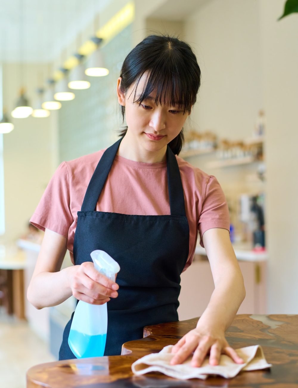Waitress cleaning table after guest